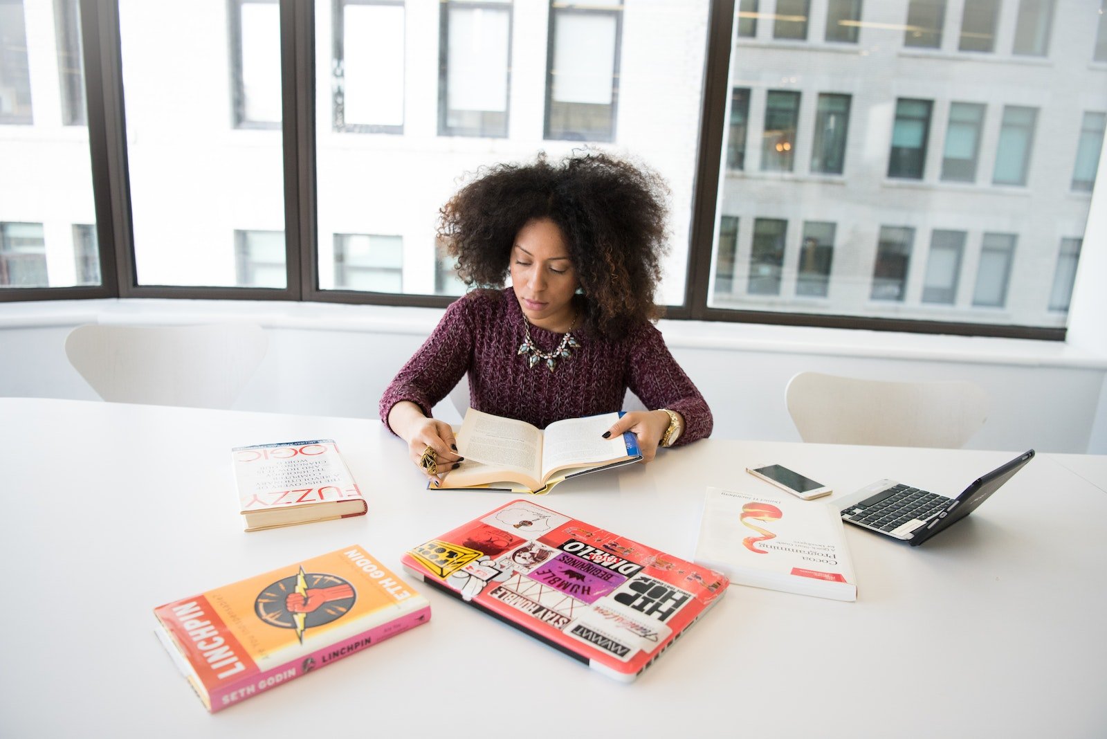 Woman Reading Book While Sitting